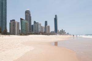 a beach with a large body of water at Costa D'Ora Holiday Apartments in Gold Coast