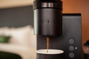 a coffee machine pouring coffee into a cup at The Swiftwater in Swiftwater