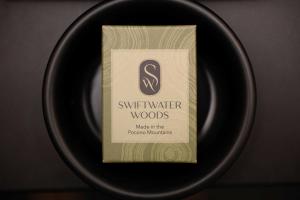 a black plate with a box of winter woods on it at The Swiftwater in Swiftwater