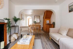 a living room with a couch and a table at Brewers Walk By The Butler Collection in Lewes