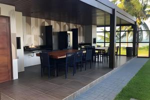 an open kitchen and dining room with a table and chairs at Prive Beira Mar Tamandare in Tamandaré
