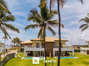 a view of a villa with palm trees at Ponta de Inhambupe Residences in Baixio