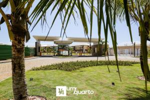 a palm tree in front of a building at Ponta de Inhambupe Residences in Baixio