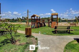 a park with a playground with a bench and a table at Ponta de Inhambupe Residences in Baixio