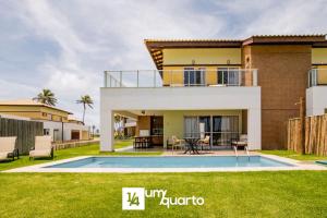 a villa with a swimming pool and a house at Ponta de Inhambupe Residences in Baixio