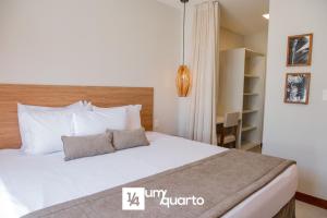 a bedroom with a large white bed with white pillows at Ponta de Inhambupe Residences in Baixio