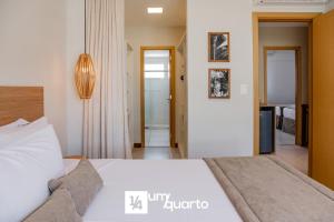 a bedroom with a large bed and a hallway at Ponta de Inhambupe Residences in Baixio