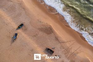 three boats sitting on the beach near the ocean at Ponta de Inhambupe Residences in Baixio