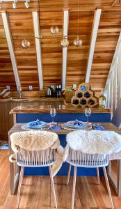 a kitchen with a table and two chairs at Cabana Snowflake Urubici in Urubici