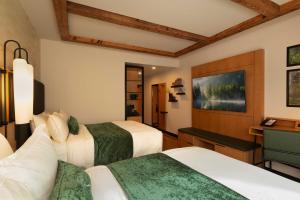 a hotel room with two beds and a desk at The Swiftwater in Swiftwater