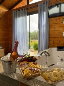 a table with a bunch of food and glasses of wine at Cabanas Colina Do Sol in Cambara do Sul