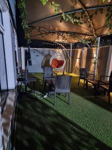 a group of chairs and tables under a tent at JKA 1-BEDROOM-Apart 24HRS POWER Unlimited WIFI , GARDEN PATIO AREA ,FREE DAILY HOUSEKEEPING in Lagos
