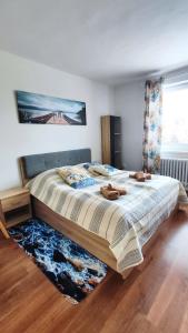 a bedroom with a large bed with shoes on it at Apartmány Chalúpkova ulica Prešov - Solivar in Prešov