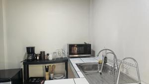 a kitchen with a sink and a microwave at El Castillo Harmony in El Castillo de La Fortuna