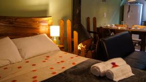 a bedroom with a bed with red hearts on it at Verde Mauá Chales in Visconde De Maua