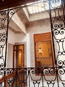 a balcony with a gate and a door in a building at Dar ZaZ in Fès