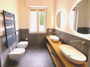 a bathroom with two sinks and two toilets at Zeus - Luxury Apartment in Como +58 photos