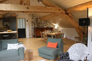 a room with a table and chairs and a dining room at Les cimes de l'Oustal in Ax-les-Thermes