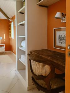 a dining room with a table and a chair at Casa Ponta de Areia in Corumbau +43 photos