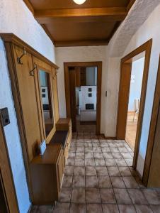 a hallway of a house with a sink and mirror at Spacious Room in Tyrolean Flat in Innsbruck