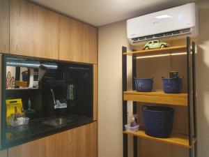 a kitchen with a sink and a shelf with a car on it at Container Beija-Flor com SPA e Cachoeira in Brotas
