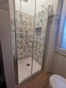 a shower with a glass door in a bathroom at La casa di Enrico & Giusy in Passoscuro +3 photos