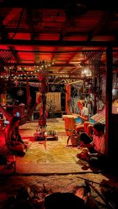 a group of people sitting on the floor of a room at Ave de Montaña Cabañas in El Zaino