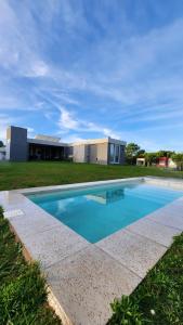 a swimming pool in front of a building at Costa Esmeralda Casa Ecu in Costa Esmeralda +10 photos