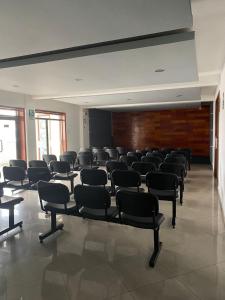 a room with rows of chairs in a building at Gran Hotel Victoria in Tacna