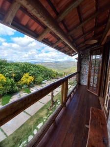 a view from the balcony of a house with a wooden deck at Pousada Cachoeiras do Cipó in Serra do Cipo +37 photos