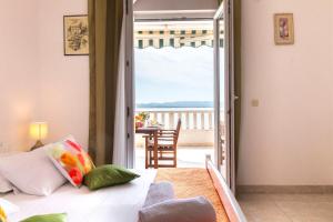a room with a bed and a view of the ocean at Apartments Villa Smokvina in Bogomolje +101 photos