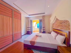 a bedroom with a large bed in a room at Shanzu Reef Beachfront Apartments in Mombasa +49 photos