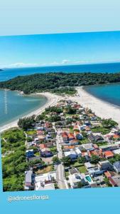 an aerial view of a city with a beach at Linda casa 3 Praia Ponta do Papagaio 190mt mar in Palhoça