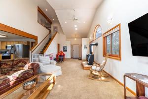 a living room with a couch and a tv at Stand-alone Mountain Home, Private Hot Tub and Deck by Summit County Mountain Retreats in Silverthorne