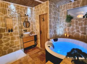 a bathroom with a large tub and a shower at Les Spas de la mer, Suite & Spa, Love room, Plein Cœur du Grau in Le Grau-du-Roi