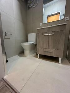 a bathroom with a sink and a toilet and a mirror at Trendy Villas Hostel in Vila Chã +49 photos