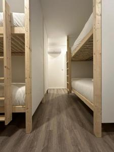 a room with two bunk beds and a hallway at Trendy Villas Hostel in Vila Chã