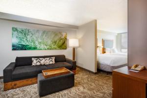 una camera d'albergo con un divano e un letto di SpringHill Suites by Marriott Miami Airport South Blue Lagoon Area a Miami