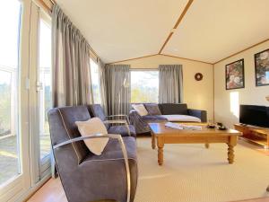 a living room with a couch and a table at Vakantiehuis Haas in Hulshorst