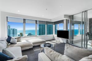 a living room with a couch and a tv at Q1 Resort & Spa - Official in Gold Coast