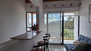 a living room with a counter with chairs and a table at Apartamento Entero 201 NUEVO in Guatavita