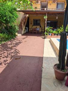 a patio of a house with a cactus at Pousada recanto do sabiá in Mangaratiba