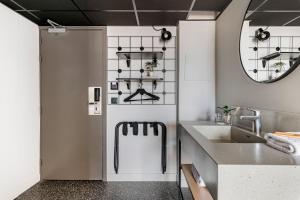a bathroom with a refrigerator and a sink at Moxy Annecy in Annecy