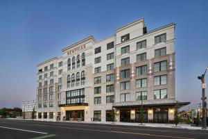 a large white building on the side of a street at The Memphian a Tribute Portfolio Hotel in Memphis