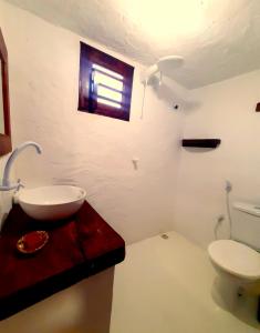 a bathroom with a sink and a toilet at Vila Ascensão in Tatajuba +42 photos