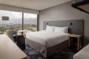 a hotel room with a bed and a large window at Fairfield by Marriott Bogota Embajada in Bogotá +107 photos
