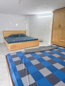 a bedroom with two beds and a checkered floor at Yellow Homestay - Venuestay in Phú Thọ +22 photos