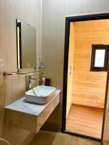 a bathroom with a sink and a mirror at Yellow Homestay - Venuestay in Phú Thọ