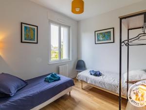 a bedroom with two beds and a bunk bed at Maison rénovée avec jardin proche d'Angers - FR-1-622-92 in Rochefort-sur-Loire