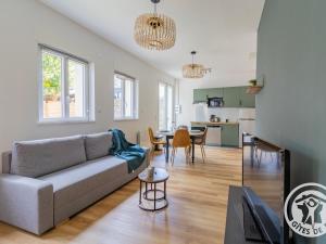 a living room with a couch and a table at Maison rénovée avec jardin proche d'Angers - FR-1-622-92 in Rochefort-sur-Loire